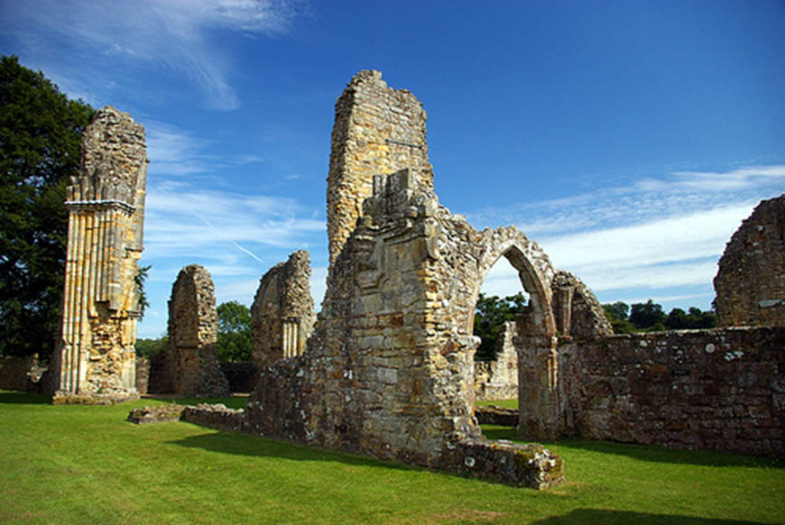 ruins of  an old abbey set against clear blue sky